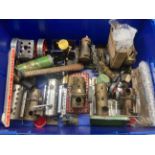 A large box of various static steam engines and parts, all incomplete.