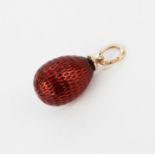 A Russian hallmarked 14ct gold and enamelled egg pendant, L. 2.5cm.
