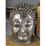 A large silvered composition Buddha head, H. 44cm.