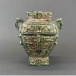 A Chinese archaic form green reconstituted stone vase, H. 20cm.