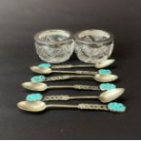 A pair of hallmarked silver and cut glass salts together with a set of six tested silver and