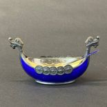 A sterling silver and enamelled Viking boat salt and spoon with glass lining, L. 9cm. H. 4cm.