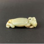 A Chinese russet jade/hardstone figure of a mythical creature, L. 8cm.