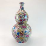 A large Chinese porcelain double gourd vase with "thousand flowers" decoration and four character
