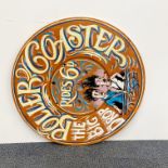 A painted ply-wood fairground sign, Dia. 75cm.