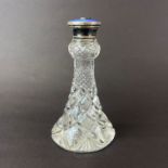 A sterling silver and enamel topped cut glass perfume bottle, H. 14cm.