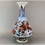 An octagonal Chinese porcelain vase with underglaze blue and red decoration, H. 37cm.