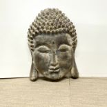 A composition wall mounted Buddha head, W. 40cm. H. 56cm.