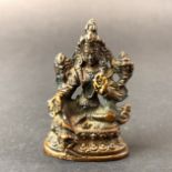 A small bronze Tibetan figure of the goddess Tara, H. 6cm.