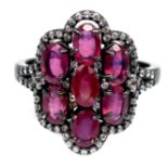 A 925 silver ring set with oval cut rubies and white stones, (O).