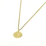 A hallmarked 9ct yellow gold St Christopher pendant, dia. 2.5cm. on a 9ct yellow gold chain.