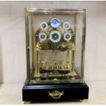 A contemporary gilt brass rolling ball congreave mantel clock. H. 43cm. W. 30cm.