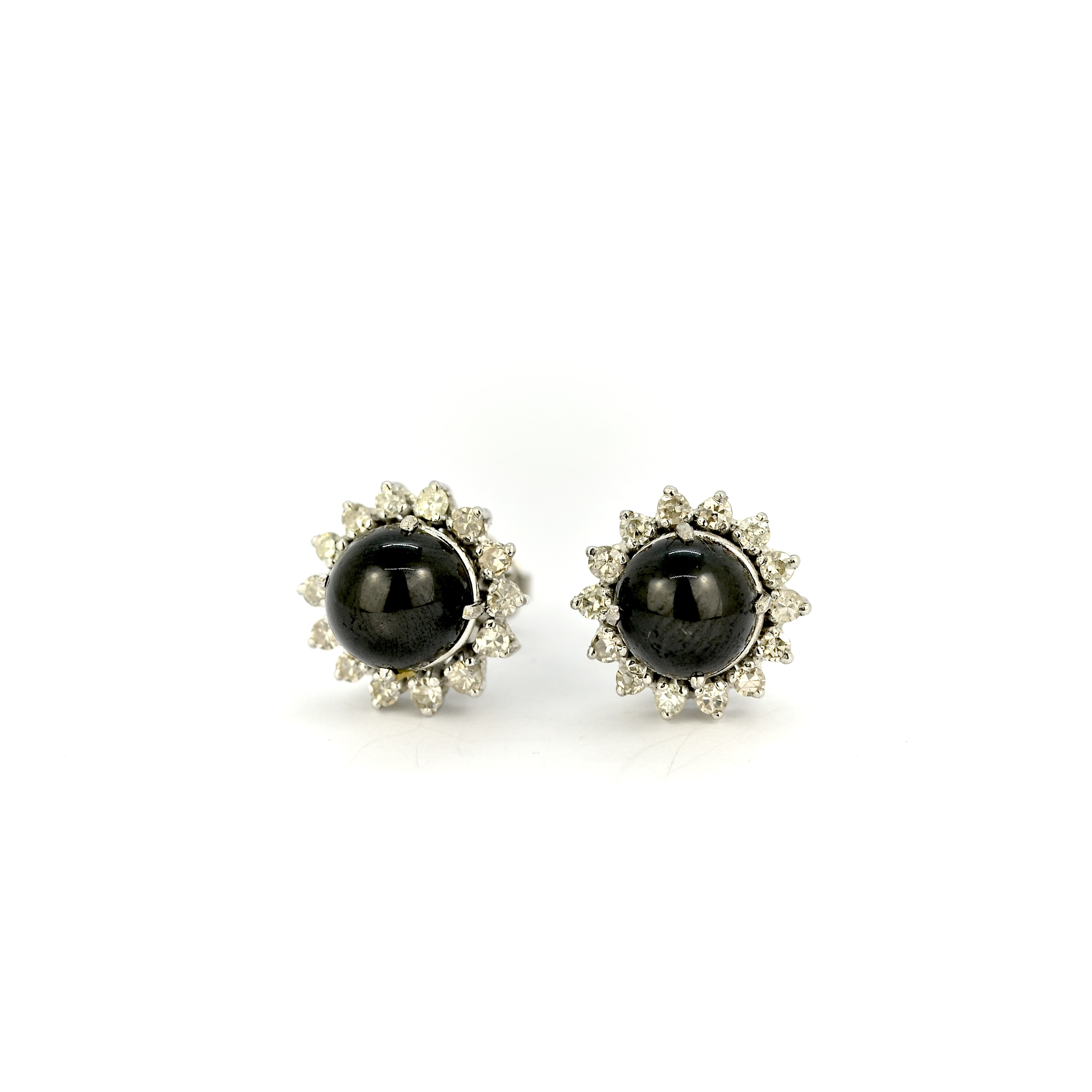 A pair of 18ct white gold cluster stud earrings each set with a cabochon star sapphire