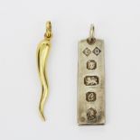 A hallmarked 9ct yellow gold Horn of plenty pendant, L. 5cm, together with a hallmarked silver ingot