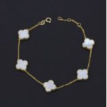 An 18ct yellow gold and mother of pearl clover bracelet, L. 19cm.