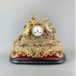 A 19th Century French gilt spelter mantel clock with wooden base. Clock H. 33cm. W.40 cm.