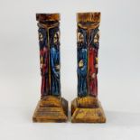 A pair of carved wooden candle sticks, H. 36cm.