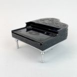 An Oriental 'PT.11121' bakelite and chromium plated piano shaped music box., 13 x 15 x 7cm.