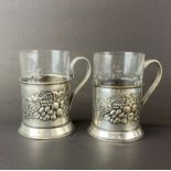 A pair of Russian .800 silver mugs with original glass linings, H. 11cm. Tested silver and