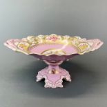 A continental pink glazed and gilt porcelain centrepiece, H. 17cm. W. 39cm.