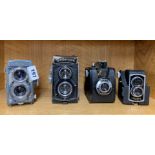 A Yashica '44 twin lense reflex camera and three others.