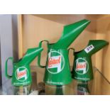 A graduated set of three Castrol advertising jugs, tallest 25cm.