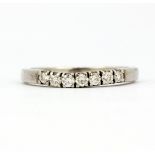 A white metal (tested minimum 18ct) diamond set half eternity ring, (N).