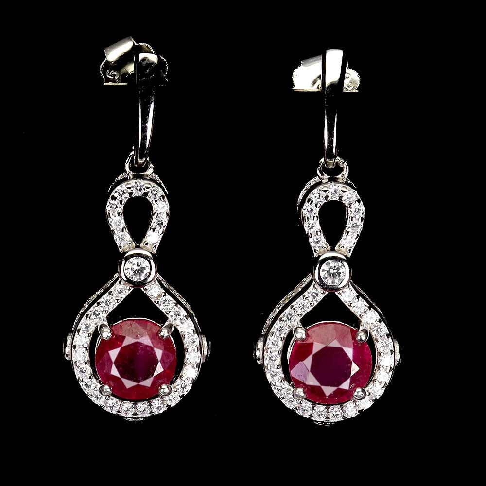 A pair of 925 silver drop earrings set with round cut rubies and white stones, L. 2.9cm.