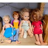 A group of four vintage doll figures.