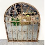 An arched metal garden mirror with doors, W. 69cm. H. 89cm.