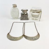 A hallmarked silver topped inkwell with a silver topped cut crystal smelling salts bottle, further