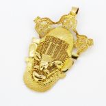 A large yellow metal (tested approximately 18ct gold) pendant depicting a Nigeran Festac figure,