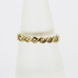 A hallmarked 9ct yellow gold diamond set half eternity ring, (O).