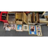 A large quantity of picture frames and photos.