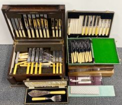 An oak cased cutlery set with two further empty cases and quantity of additional cutlery.