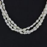 A triple row freshwater pearl necklace with an 18ct yellow gold (tested) clasp, L. 42cm.
