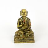 A Sino-Tibetan gilt bronze figure of a seated deity, H. 14cm.