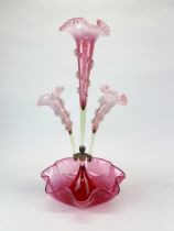 A 19th century cranberry glass epergne with cranberry and vaseline glass flutes, H. 51cm.