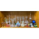 A quantity of glass paperweights and other glassware.