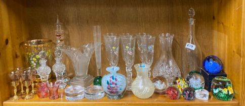 A quantity of glass paperweights and other glassware.