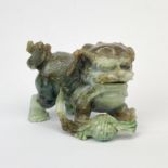 A finely carved Chinese mixed colour jade model of a lion dog, H. 6.5cm. L. 10cm.