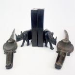 A pair of carved ebony rhinoceros bookends, H. 19cm. together with a pair of figured ebony crocodile