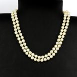 A double strand cultured pearl necklace with a 9ct yellow gold clasp set with a large oval cut