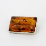 A silver mounted amber set brooch, 3 x 2cm.