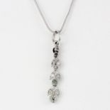 An 18ct white gold (tested) drop pendant set with rose cut diamonds on a 14ct white gold (marked