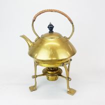 An Arts and Crafts hammered brass spirit kettle and stand, H. 29cm.