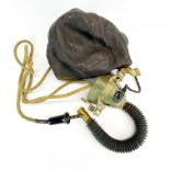 A WWII pilots helmet, mask and radio wire.