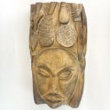 A large carved wooden tribal mask, H. 53.