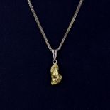 A high carat (tested minimum 18ct) gold nugget charm on a 9ct yellow gold chain, L. 44cm.