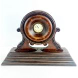 An early 20th century mantle clock incorporating an aeroplane propeller boss, W. 45cm. H. 32cm.